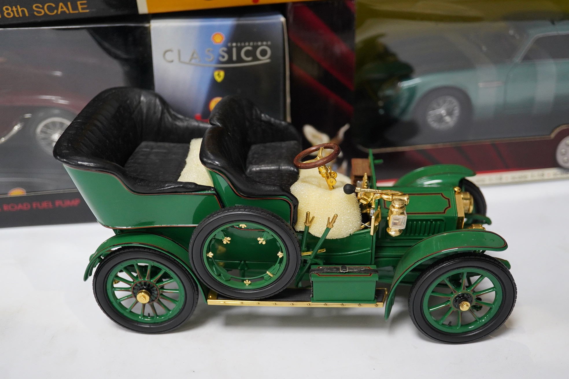 Five boxed large scale diecast cars; a 1:16 scale Franklin Mint 1905 Rolls-Royce 10hp, with one wheel detached and one side lamp detached (both present), together with four 1:18 scale cars; a Chrono Aston Martin DB5, a R